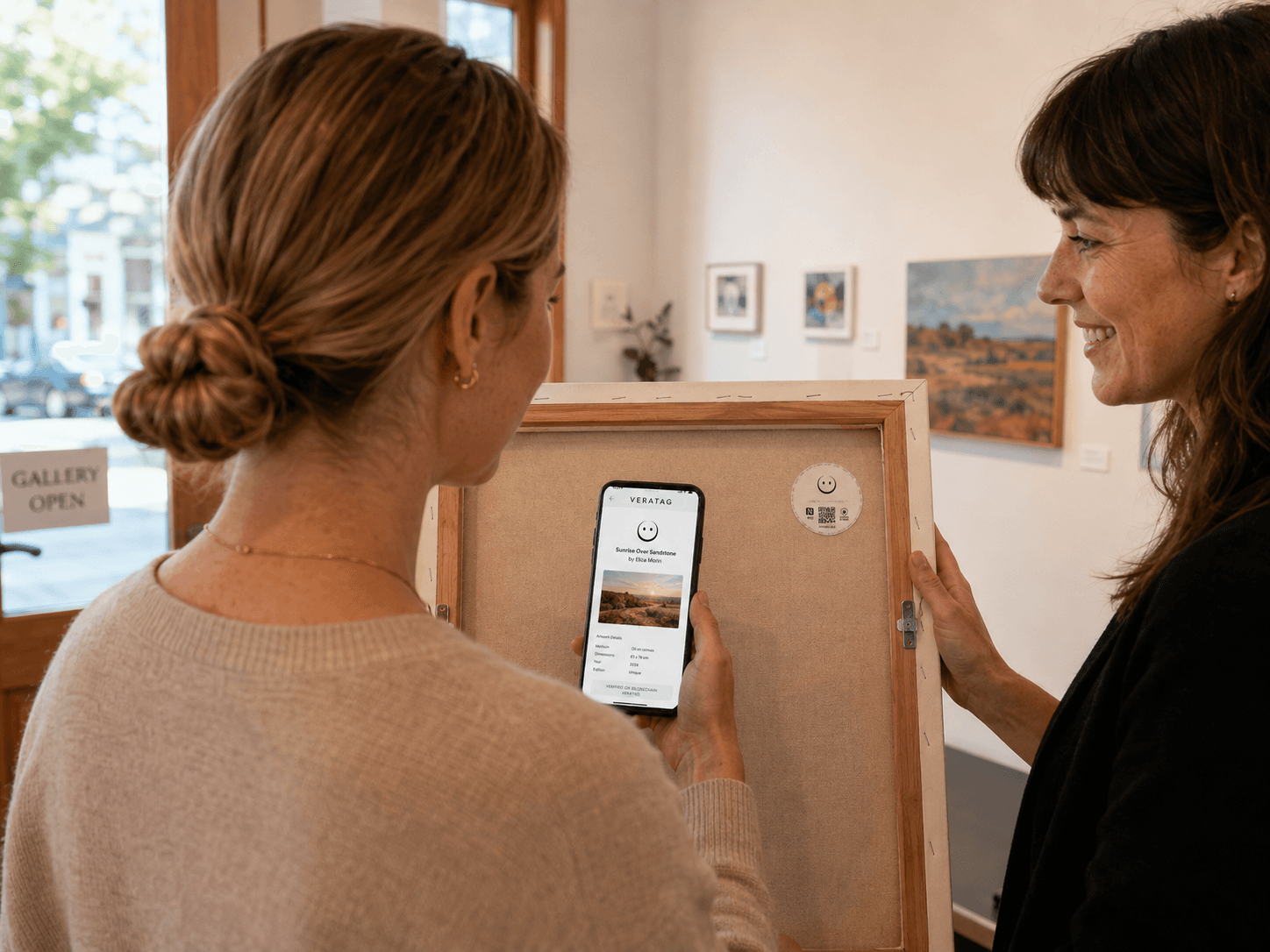 An artwork handover with its physical tag and digital passport visible